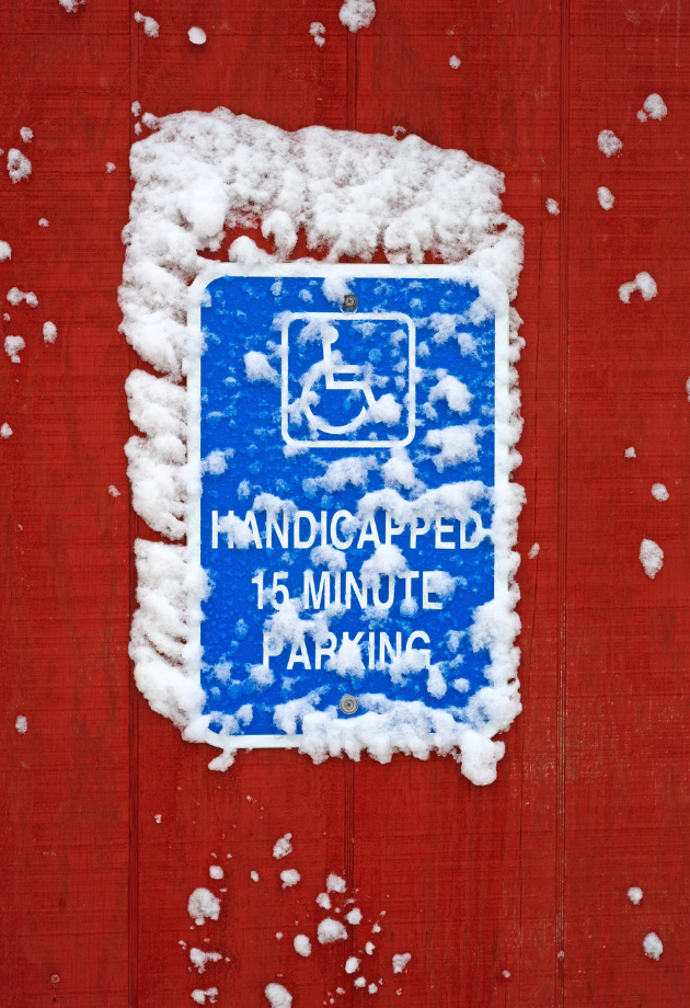 snow covered handicapped parking sighn